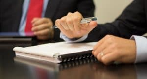 Hands of people at a meeting | selecting an employment lawyer