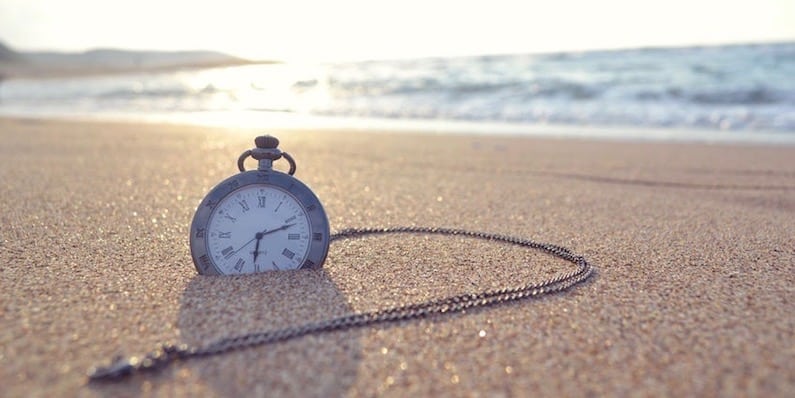Vacation Benefits - Time clock on a beach