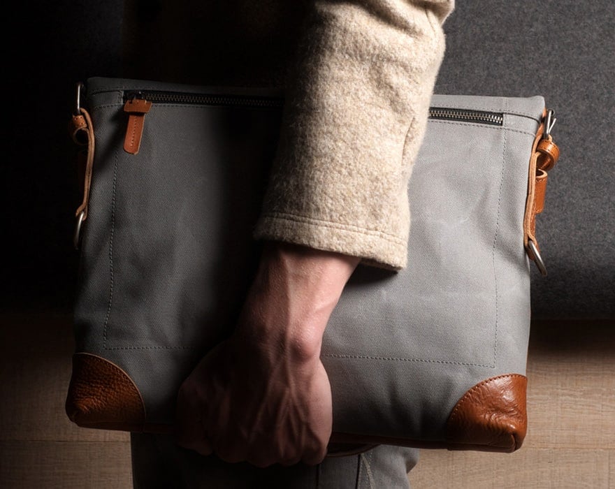 Image of a man's arm clutching a gray bag with leather trim | Toronto Employment Lawyers | notice and Severance