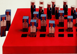 Red chessboard with wooden managers and workers as opposing players