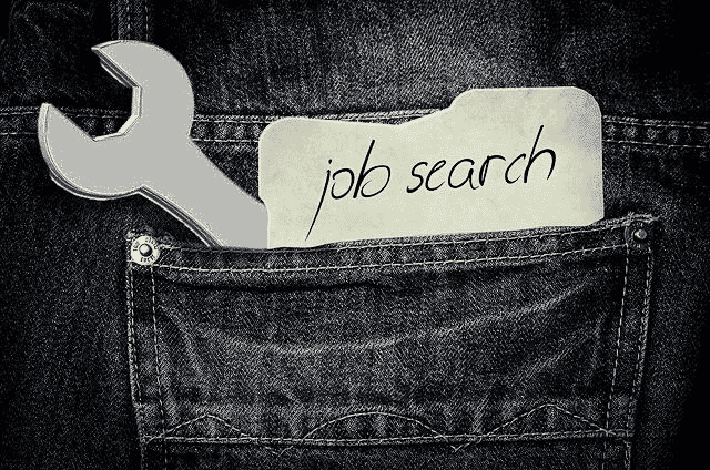 Denim pocket with a wrench sticking out and and a note reading job search | Severance Pay and Employment Insurance