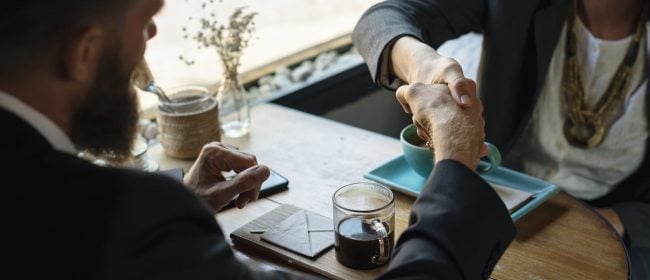Man & Woman shaking hands over a coffee | Commission Sales Agents