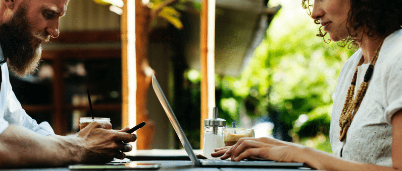 Pay Equity | man and woman working at a table